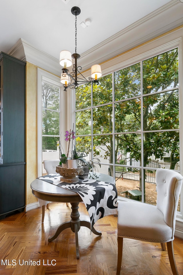 dining area with a notable chandelier, parquet floors, and crown molding