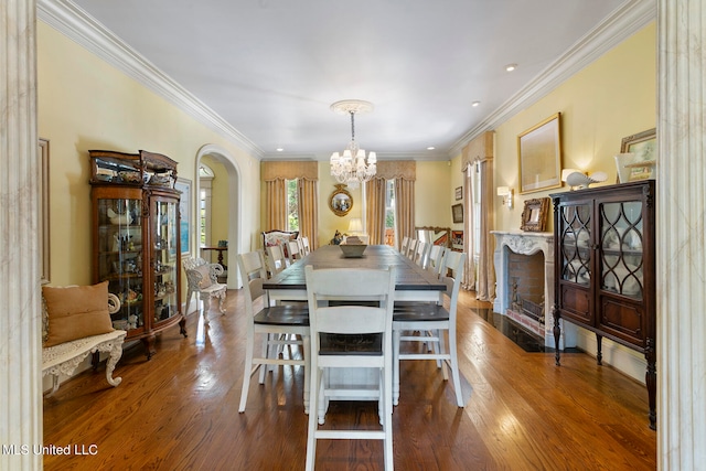 dining area featuring crown molding, an inviting chandelier, and hardwood / wood-style floors