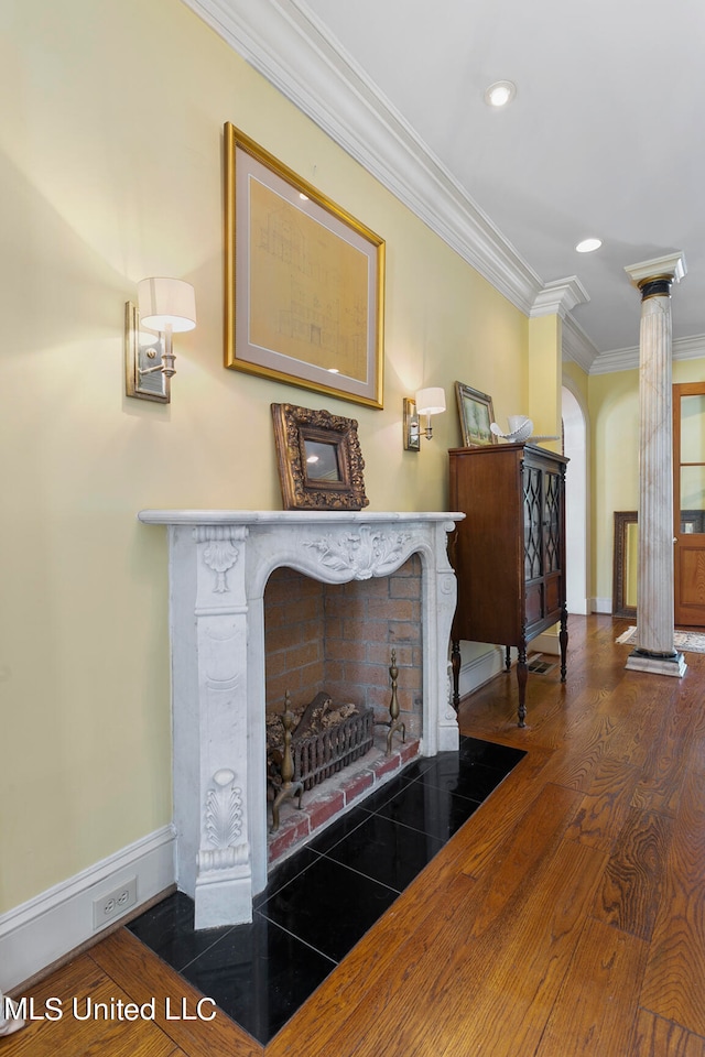 interior space with ornamental molding and dark hardwood / wood-style floors