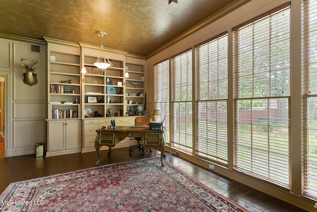 office area featuring ornamental molding, built in shelves, and a wealth of natural light