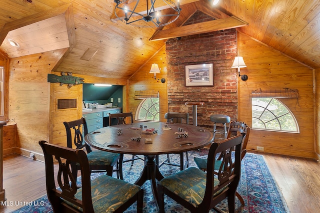 dining space with light hardwood / wood-style flooring, lofted ceiling, and wood ceiling