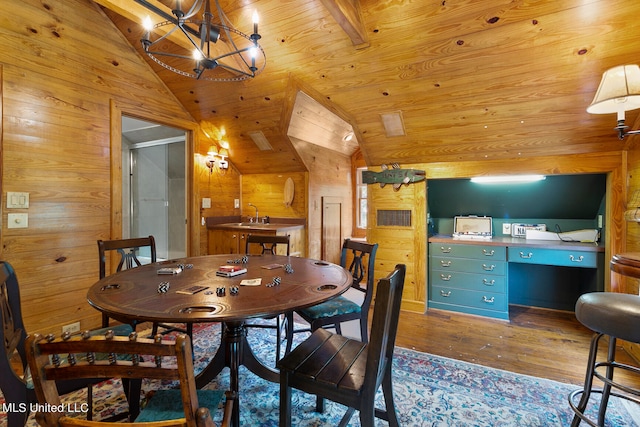 dining space featuring wood walls, wood-type flooring, vaulted ceiling, and wooden ceiling