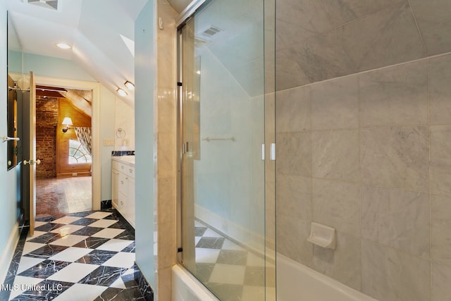 bathroom featuring vanity and lofted ceiling