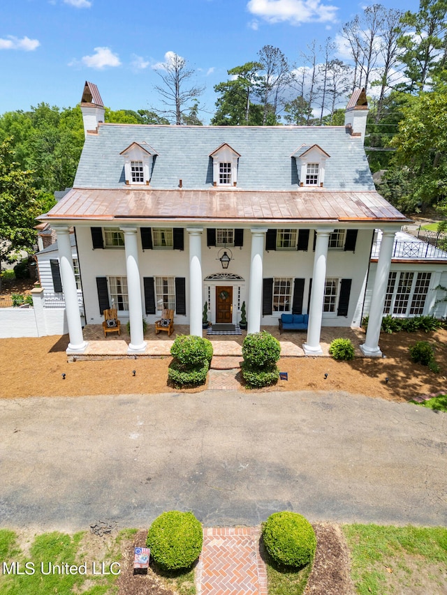 greek revival house featuring covered porch