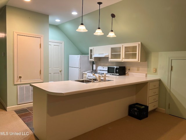 kitchen featuring white appliances, kitchen peninsula, lofted ceiling, dark colored carpet, and ventilation hood