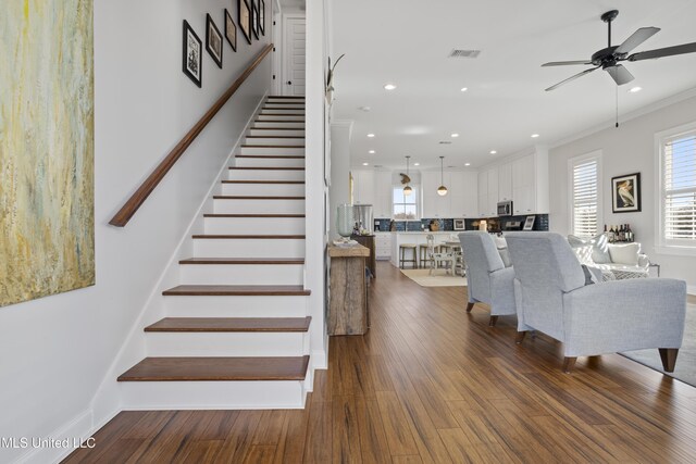 122 Aiken Rd, Waveland, MS 39576 - staircase with visible vents, recessed lighting, crown molding, and wood finished floors