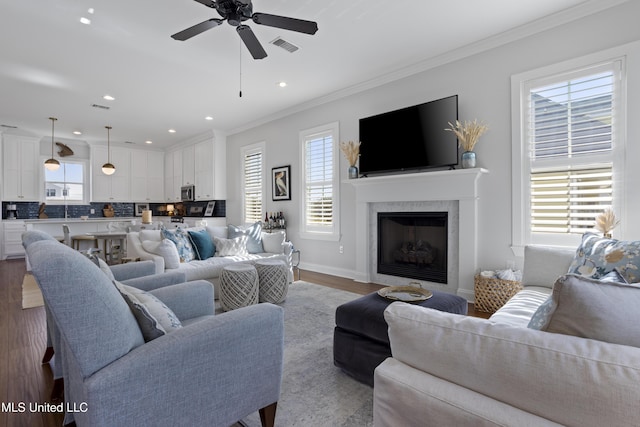 122 Aiken Rd, Waveland, MS 39576 - living area with wood finished floors, recessed lighting, a fireplace, crown molding, and baseboards
