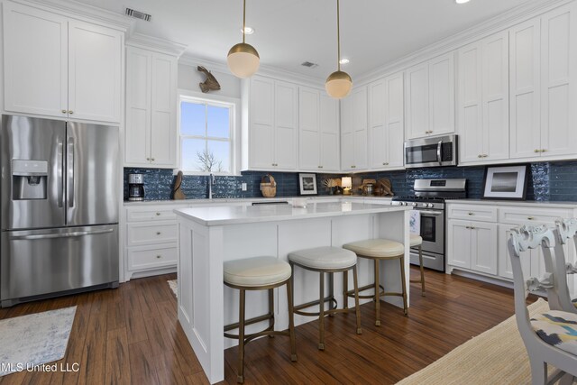 122 Aiken Rd, Waveland, MS 39576 - kitchen with visible vents, white cabinetry, stainless steel appliances, decorative backsplash, and dark wood-style flooring