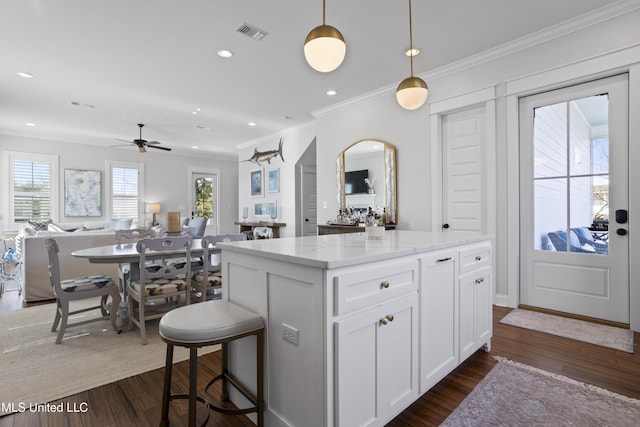 122 Aiken Rd, Waveland, MS 39576 - kitchen with dark wood finished floors, visible vents, open floor plan, and ornamental molding