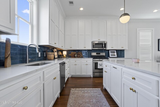 122 Aiken Rd, Waveland, MS 39576 - kitchen with visible vents, dark wood finished floors, a sink, stainless steel appliances, and white cabinets