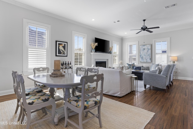 122 Aiken Rd, Waveland, MS 39576 - dining space with visible vents, a fireplace, dark wood-type flooring, and ornamental molding