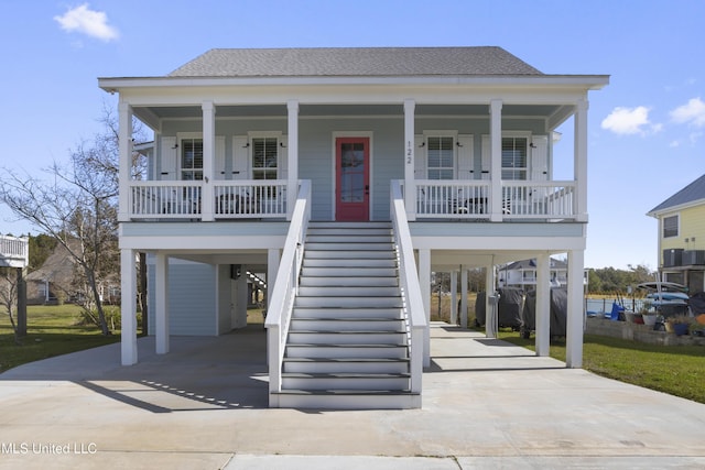 122 Aiken Rd, Waveland, MS 39576 - coastal home featuring a carport, covered porch, and driveway