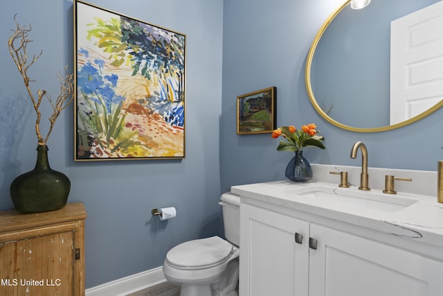 122 Aiken Rd, Waveland, MS 39576 - bathroom featuring toilet, vanity, and baseboards