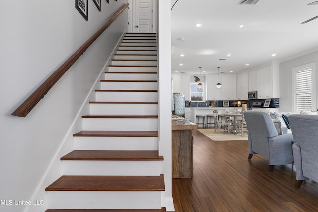 122 Aiken Rd, Waveland, MS 39576 - stairs featuring recessed lighting, visible vents, wood finished floors, and ornamental molding