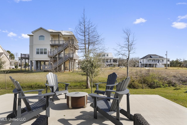 122 Aiken Rd, Waveland, MS 39576 - view of patio featuring stairs, a balcony, and an outdoor fire pit