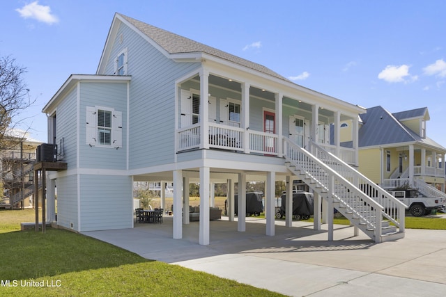 122 Aiken Rd, Waveland, MS 39576 - view of front of home with roof with shingles, a porch, stairs, a carport, and concrete driveway