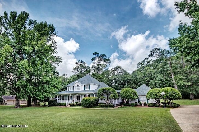farmhouse with a porch and a front yard