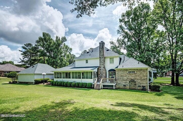 rear view of property featuring a sunroom and a lawn