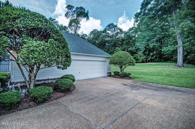 garage featuring a lawn