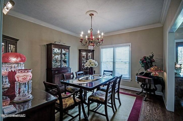 dining room with an inviting chandelier, crown molding, dark wood-style floors, and baseboards