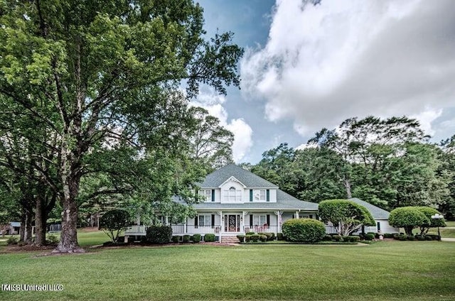 farmhouse with covered porch and a front lawn