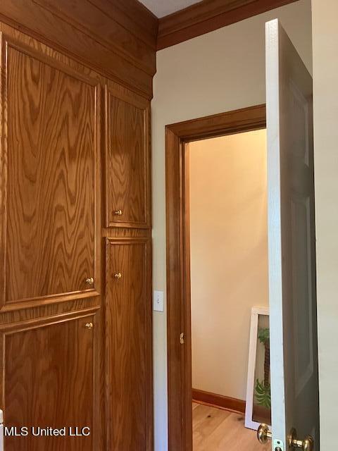 interior space featuring wood finished floors and baseboards