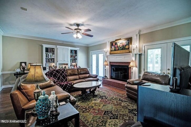 living room with ceiling fan, dark wood-style floors, baseboards, a fireplace, and french doors