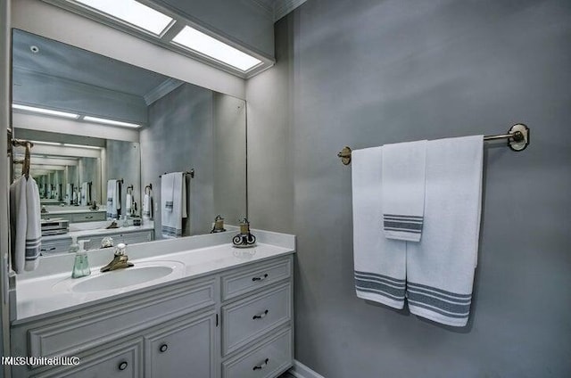 bathroom with crown molding and vanity