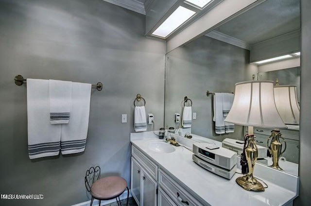 bathroom with vanity and ornamental molding