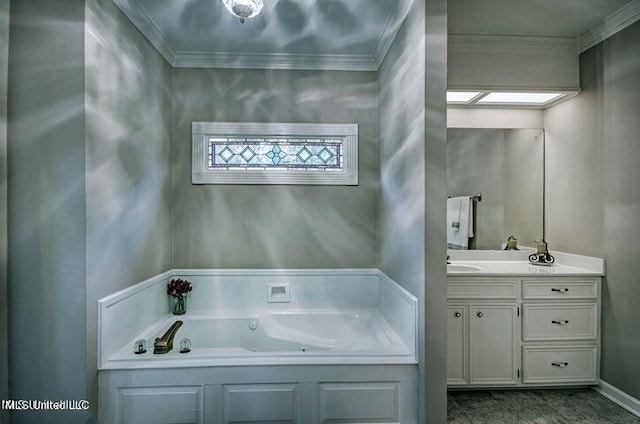 bathroom with a tub with jets, ornamental molding, and vanity