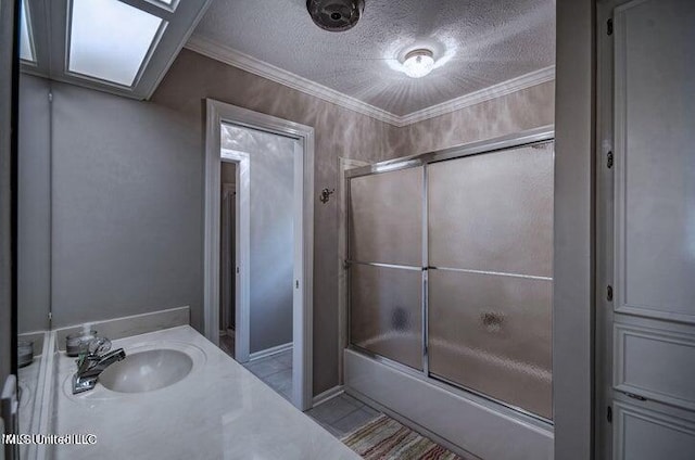 full bathroom featuring shower / bath combination with glass door, a textured ceiling, ornamental molding, and vanity