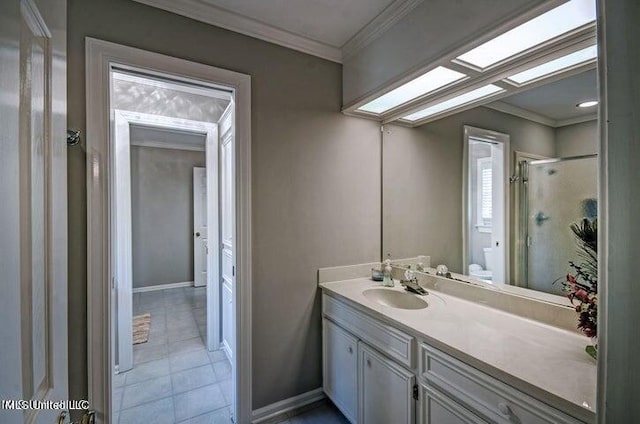 full bath with tile patterned flooring, toilet, vanity, a stall shower, and crown molding
