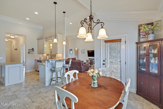 dining area with baseboards, a chandelier, crown molding, and recessed lighting