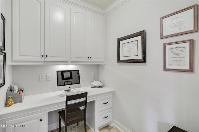 office with baseboards, crown molding, and built in study area