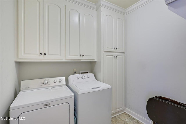 clothes washing area featuring independent washer and dryer, cabinet space, and baseboards