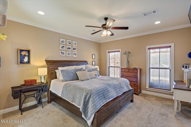 bedroom with multiple windows, visible vents, crown molding, and light colored carpet