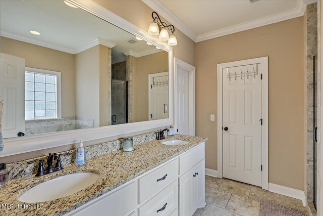 full bath featuring double vanity, ornamental molding, a sink, and a shower stall