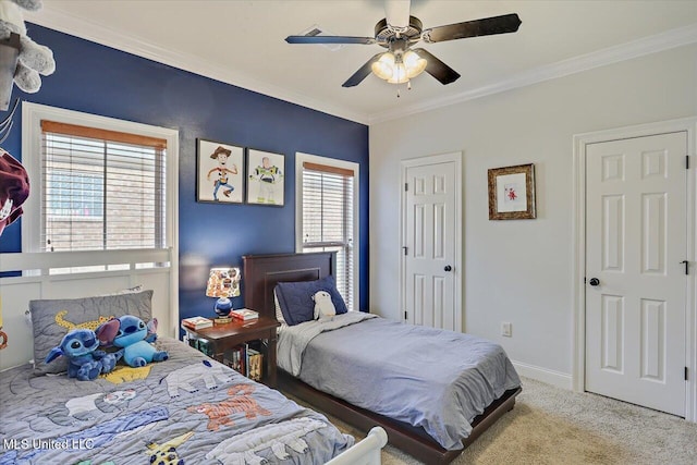 bedroom with carpet floors, ornamental molding, a ceiling fan, and baseboards