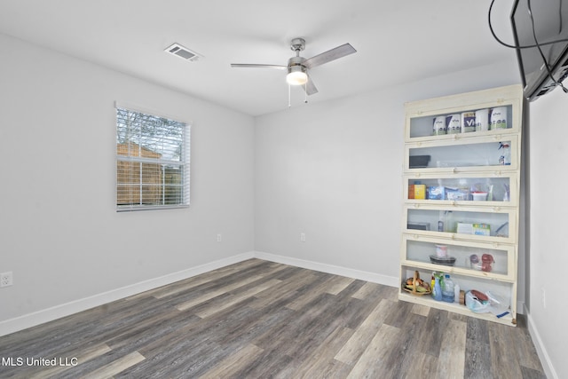 spare room with ceiling fan and dark hardwood / wood-style flooring