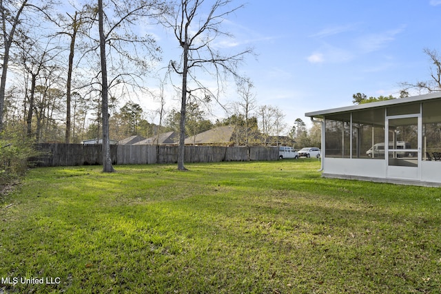 view of yard with a sunroom