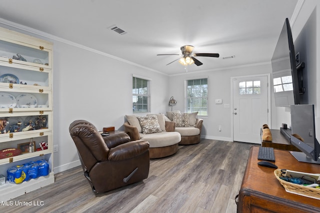 living room featuring ceiling fan, crown molding, and wood-type flooring