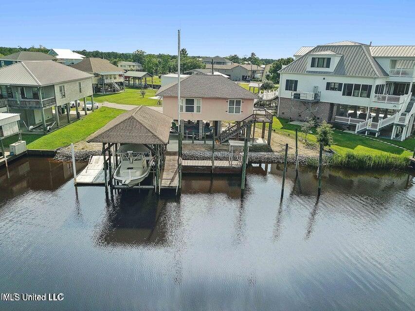 view of dock featuring a lawn and a water view