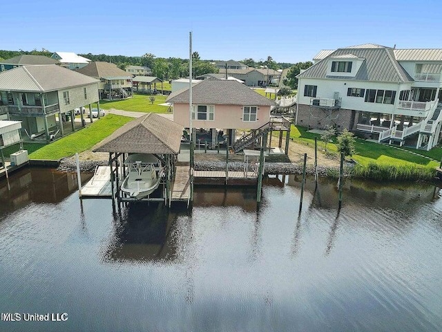 view of dock featuring a lawn and a water view