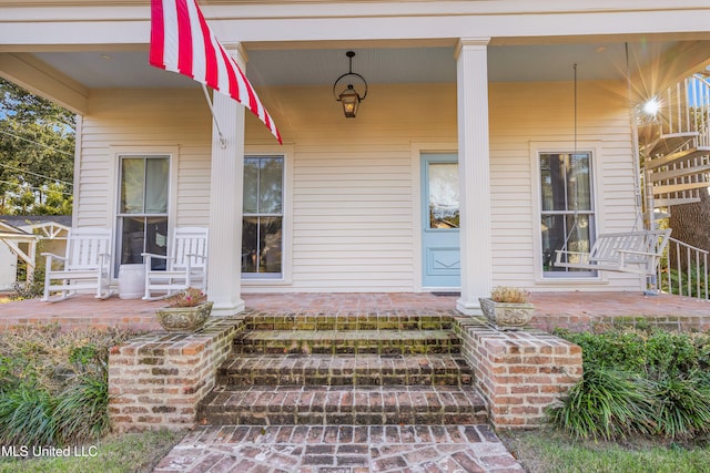 view of exterior entry with covered porch