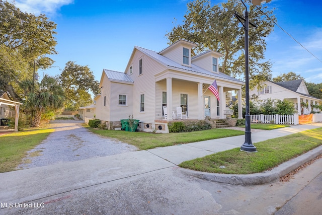 view of front of home featuring a front yard and a porch