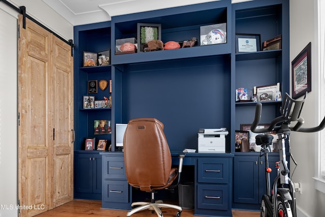 office area with built in desk and wood-type flooring