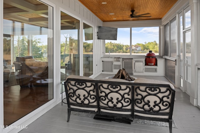 sunroom / solarium featuring sink and wooden ceiling