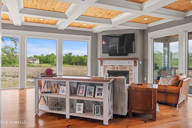 living room featuring wooden ceiling, beamed ceiling, coffered ceiling, and light wood-type flooring