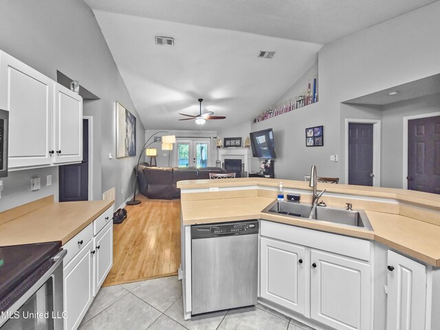 11295 Peyton Dr, Gulfport, MS 39503 - kitchen with dishwasher, a sink, lofted ceiling, open floor plan, and light countertops
