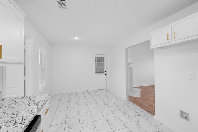 kitchen featuring white cabinetry, marble finish floor, recessed lighting, and visible vents